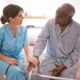 A nurse talking to a patient Description automatically generated